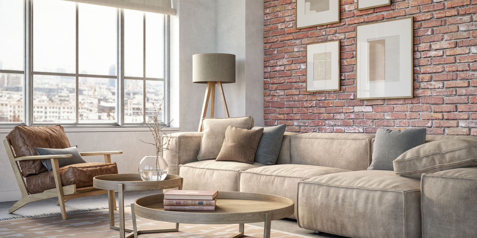 A living room with couch, frames, table, and a window.